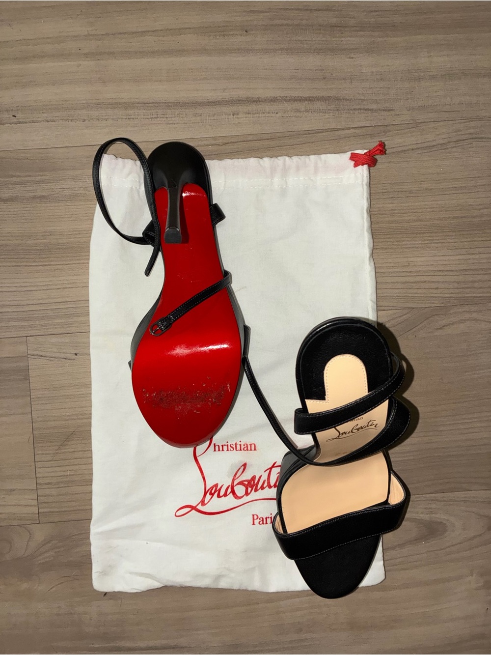Christian Louboutin black strappy heels — authentic red bottoms.